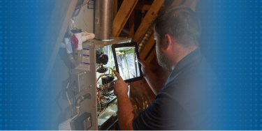 A technician performing maintenance on a heating system, showcasing reliable heating services