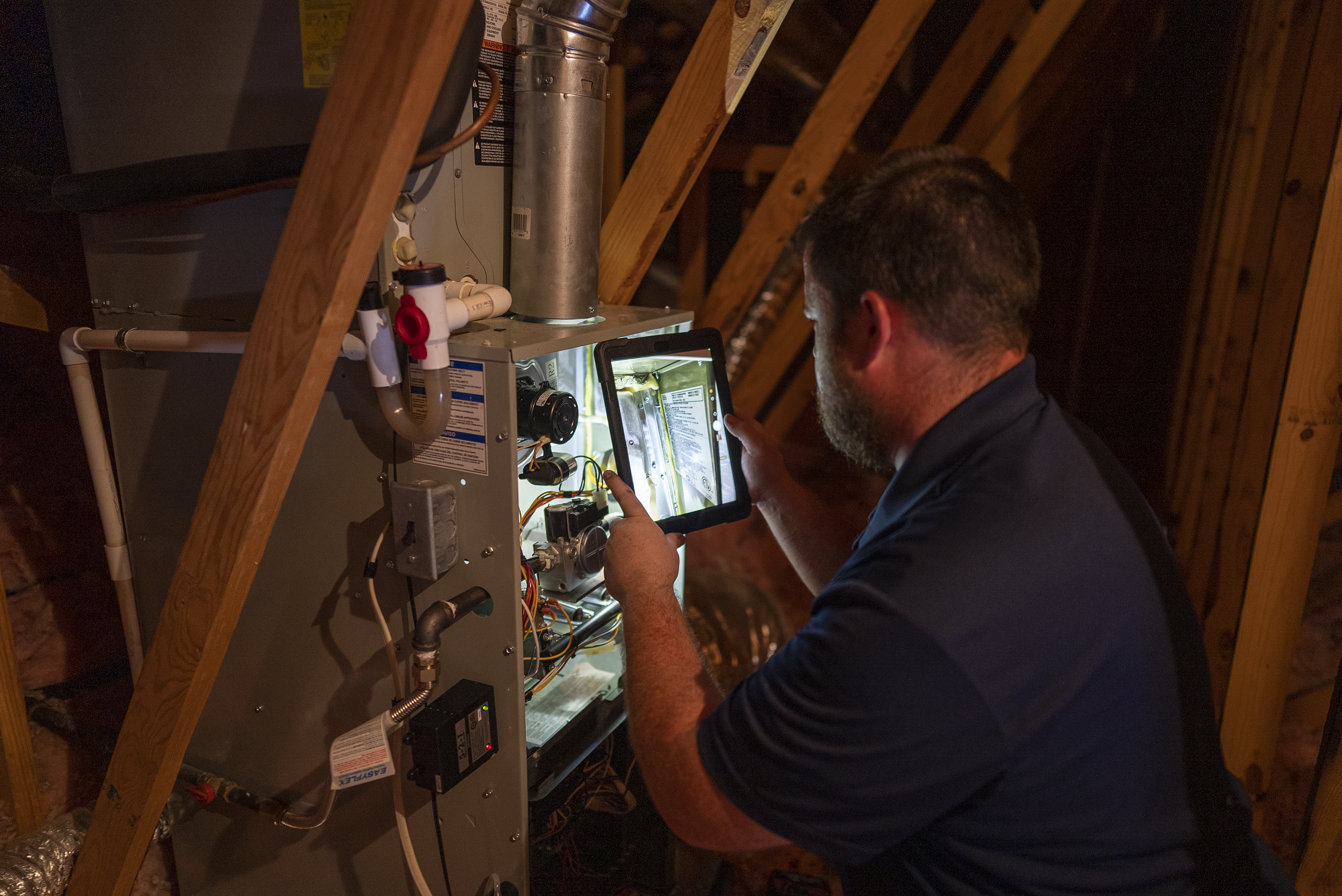 Technician working on an open heating system.